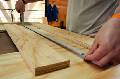 Measuring plywood for a winter DIY project at home